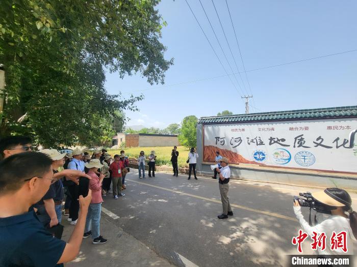 圖為中國(guó)地質(zhì)大學(xué)(北京)教授張緒教介紹村落情況。　胡友軍 攝